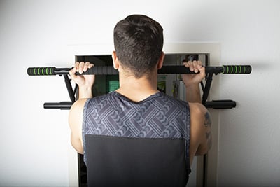 over the door pull up bar being used for chin ups