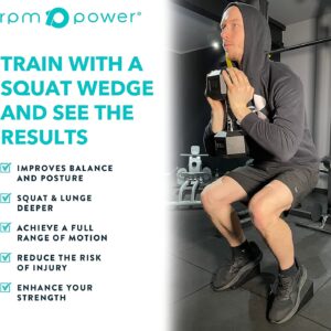 Man squatting with hex dumbbell in hand